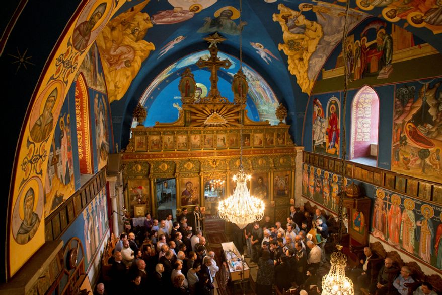 Palestinians pray during the funeral of Salem Paul Sweliem in Gaza City on Nov. 20, 2012. According to the family, the 52-year-old Greek Orthodox Christian carpenter was killed during an Israel Air Force strike on a high-rise building, in which Ramez Harb, a senior figure in Islamic Jihad's military wing, was killed. Sweliem was in car when the strike took place and died on his way to the hospital from shrapnel wounds. (Associated Press)