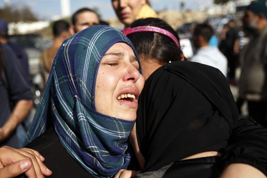 Relatives grieve Rushdi Tamimi during his funeral in the West Bank city of Ramallah on Nov. 20, 2012. Tamimi was wounded three days earlier during a protest against Israel's operation in Gaza. (Associated Press)