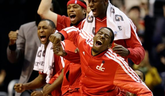 Washington Wizards' A.J. Price (left), Cartier Martin, Earl Barron, and Jordan Crawford (front right) cheer as their team pulls within one point during the second half of the Pacers' 96-89 road win on Nov. 19, 2012. (Associated Press)