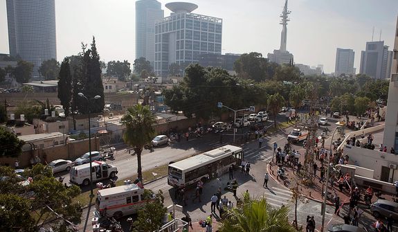 A destroyed bus is seen at the site of a bombing in Tel Aviv, Israel, Wednesday, Nov. 21, 2012. A bomb ripped through an Israeli bus near the nation's military headquarters in Tel Aviv on Wednesday, wounding several people, Israeli officials said. The blast came amid a weeklong Israeli offensive against Palestinian militants in Gaza.(AP Photo/Dan Balilty)