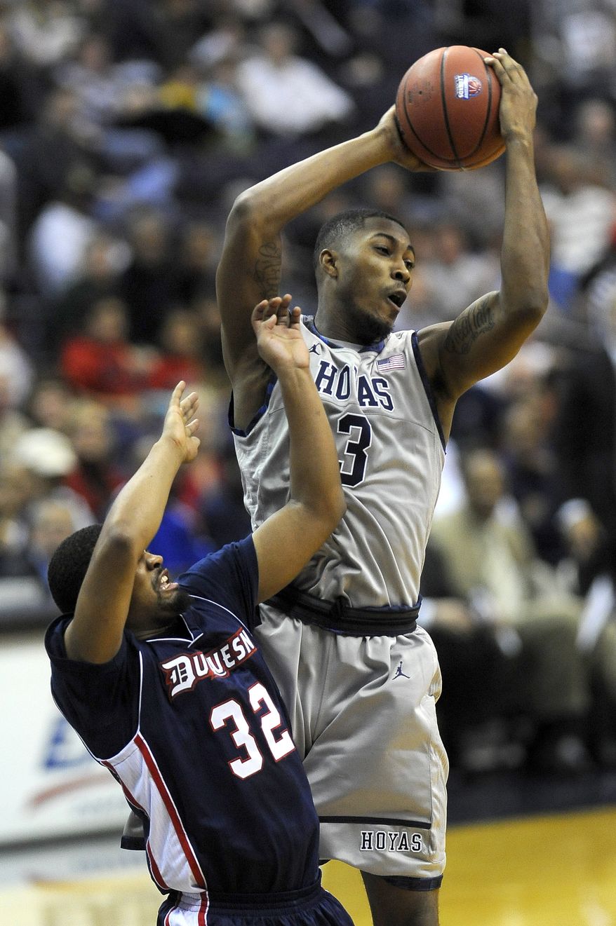 Georgetown forward Mikael Hopkins (3) grabs a rebound away from Duquesne guard Sean Johnson during their NCAA college basketball game, Sunday, Nov. 11, 2012, in Washington. Georgetown defeated Duquesne 61-55. (AP Photo/Richard Lipski)