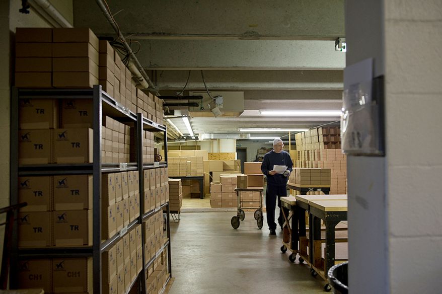 Brother Christopher Harmon goes through the list of shipments that need to be made from the Holy Cross Abbey in Berryville, Va. on Monday, Nov. 19, 2012. The monks have been making fruitcakes for nearly 40 years and sells them as a means of making money for the day-to-day operations of the monastery. They bake from January to September, with Christmas being their busiest shipping time of year. They also sell creamed honey and truffles. (Barbara L. Salisbury/The Washington Times)