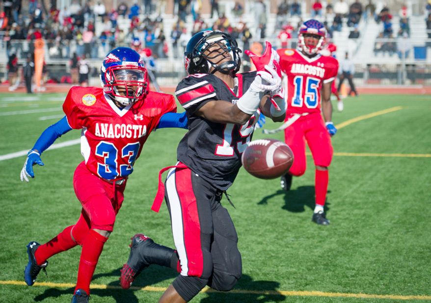 Anacostia's Xavier Harkum (33) breaks up a pass in the end zone intended for Dunbar's Michael Smith (19) in the first quarter during the 43nd Annual DCIAA Turkey Bowl Varsity Football Championship at Eastern High School in Washington, D.C., Thursday, Nov. 22, 2012. This game, played between two District high school football teams is rich in tradition and always played on Thanksgiving Day, however this year's contest had a slight change in the last few days leading up to the game when Woodrow WIlson High School was disqualified because one the team's players was found to have been a resident of Maryland. Anacostia High School was chosen as an alternative. (Rod Lamkey Jr./The Washington Times)