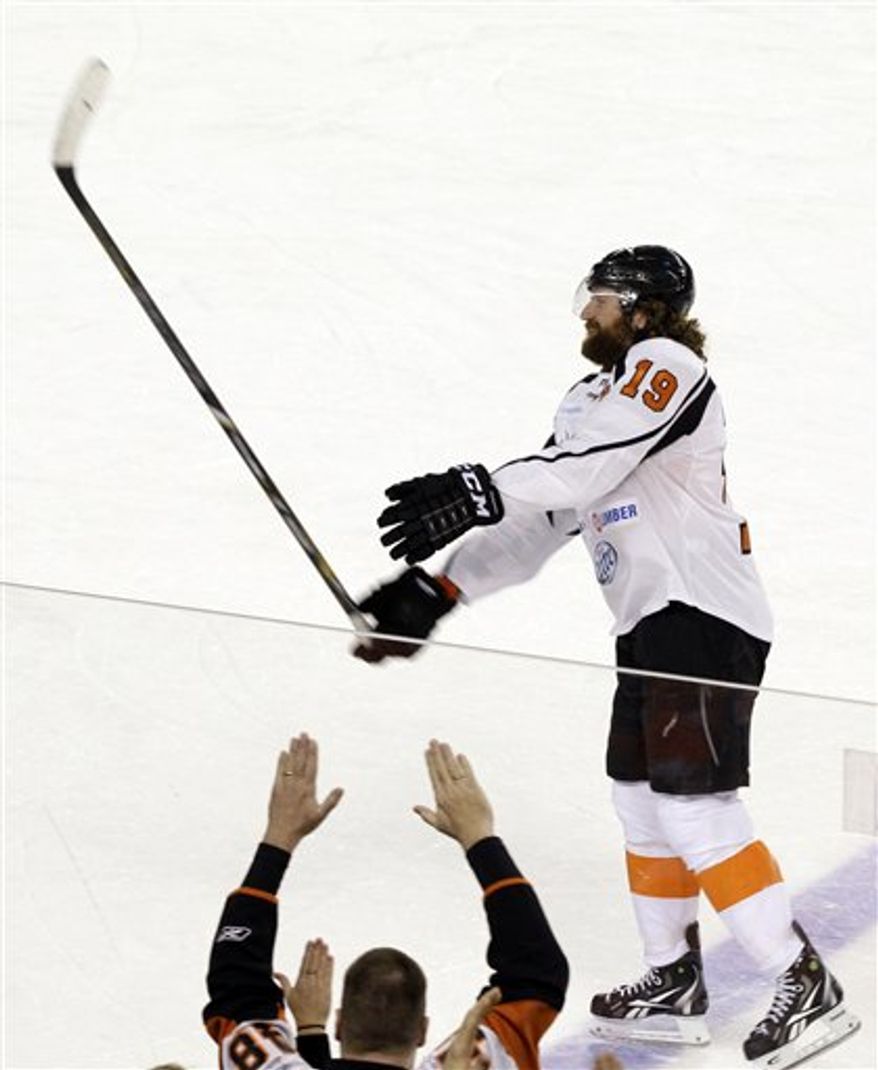 New Jersey Team's Scott Hartnell tosses his stick to fans after a charity hockey game against the New York Team in Atlantic City, N.J., Saturday, Nov. 24, 2012. New York won 10-6. (AP Photo/Mel Evans)