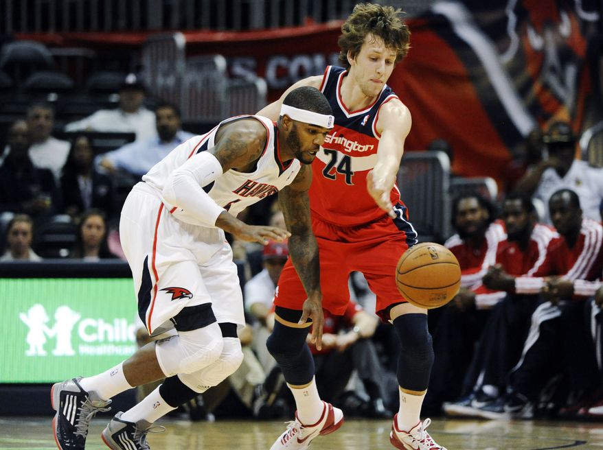 Atlanta Hawks' Josh Smith (5) steals the ball from Washington Wizards' Jan Vesely in the first half of an NBA basketball game at Philips Arena in Atlanta, Wednesday, Nov. 21, 2012. (AP Photo/David Tulis)