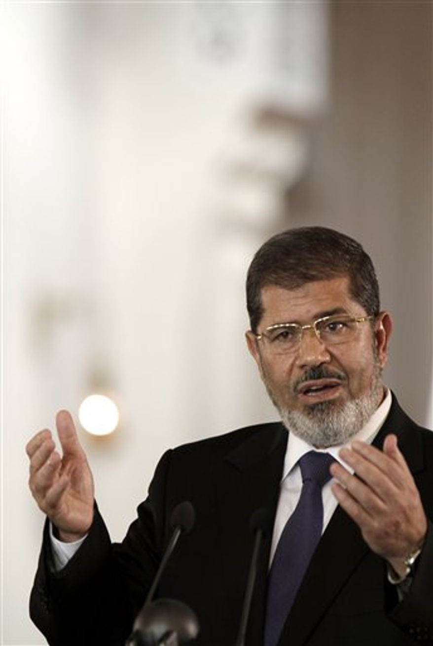 In this Friday, July 13, 2012 photo, Egyptian President Mohammed Morsi holds a joint news conference with Tunisian President Moncef Marzouki, unseen, at the Presidential palace in Cairo, Egypt. Egypt's Islamist president may look like he's running out of options as he faces an appeals court strike and massive opposition protests over decrees granting himself near absolute power. Will he back down now? Most likely not. Mohammed Morsi's next move may be to raise the stakes even higher. Signs are growing the constitutional panel at the heart of the showdown could vote on a draft this week despite a walkout by liberal and Christian members. (AP Photo/Maya Alleruzzo)
