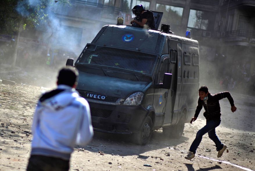 Egyptian protesters clash with security forces near Tahrir Square in Cairo on Wednesday, Nov. 28, 2012. (AP Photo/Khalil Hamra)