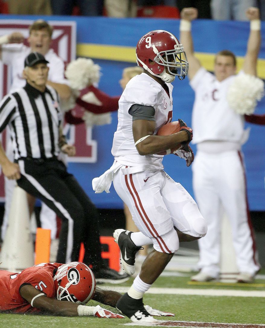 Alabama wide receiver Amari Cooper runs into the end zone as Georgia defensive back Damian Swann comes up empty on his diving tackle attempt in the SEC championship Saturday. The Crimson Tide won 32-28. (Associated Press)