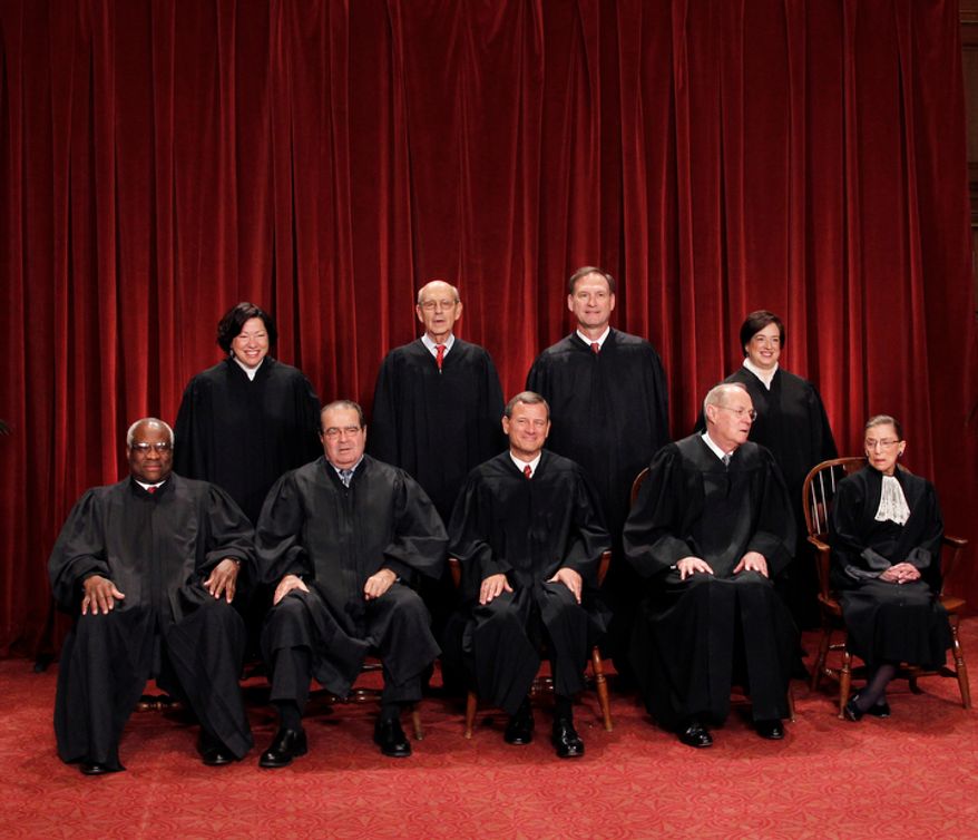 **FILE** This photo shows the justices of the U.S. Supreme Court in a group portrait at the Supreme Court Building in Washington on Oct. 8, 2010. Seated from left to right are: Associate Justice Clarence Thomas, Associate Justice Antonin Scalia, Chief Justice John G. Roberts, Associate Justice Anthony M. Kennedy, Associate Justice Ruth Bader Ginsburg. Standing, from left are: Associate Justice Sonia Sotomayor, Associate Justice Stephen Breyer, Associate Justice Samuel Alito Jr., and Associate Justice Elena Kagan. (Associated Press)