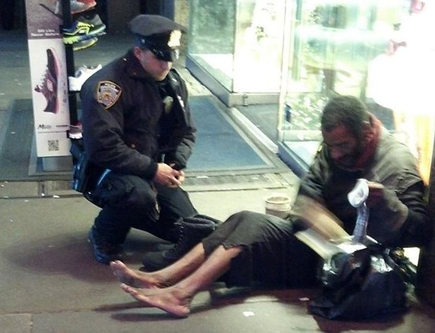 Officer Lawrence DePrimo helping Mr. Hillman/ Associated Press