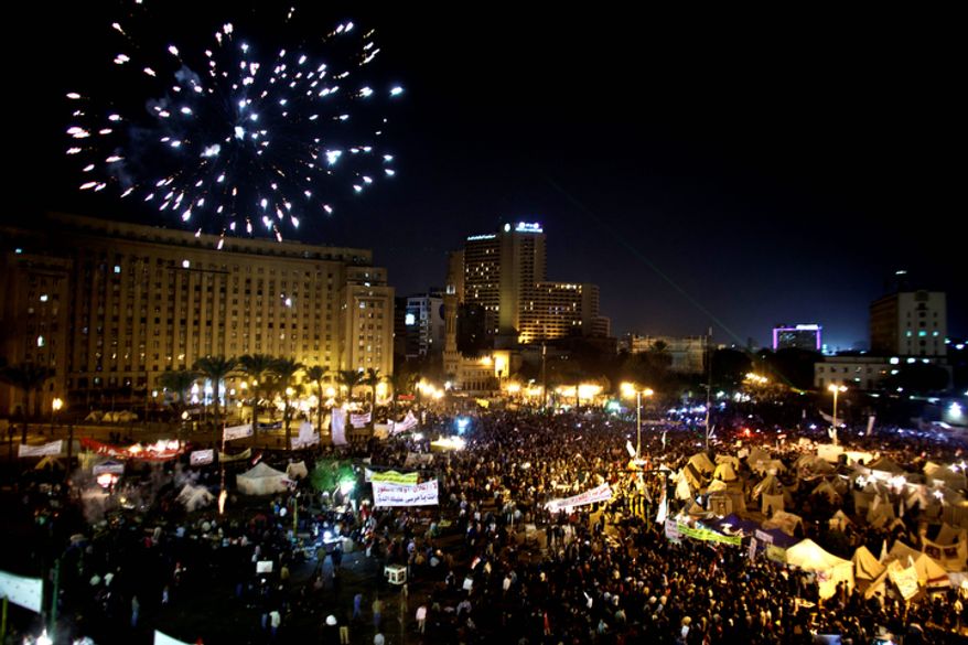 Fireworks burst over Tahrir Square as protesters gather in Cairo on Dec. 4, 2012. Demonstrations by tens of thousands of Egyptians outside the presidential palace turned violent as tensions grew over Islamist President Mohammed Morsi's seizure of nearly unrestricted powers. Thousands of protesters also gathered in Cairo's downtown Tahrir Square, miles away from the palace, to join several hundred who have been camping out there for nearly two weeks. (Associated Press)