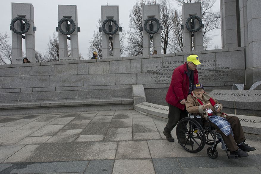 John Sekelsky of Croton-on-Hudson, N.Y. says he remembers he was ice skating on a big lake when the attack on Pearl Harbor occurred. He was in high school at the time but later enlisted in the Air Corps and served in England with the 487 Bomb Group. Here he gets a tour of the National World War II Memorial in Washington, D.C. with Dave Benbennick of the Honor Flight network before the National Pearl Harbor Remembrance Day ceremony on Friday, Dec. 7, 2012. (Barbara L. Salisbury/The Washington Times)