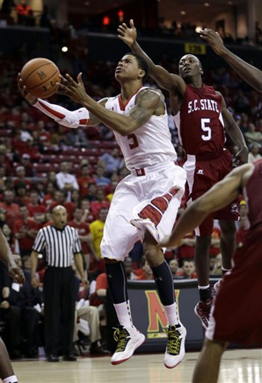 Maryland guard Nick Faust shoots past South Carolina State guard Adama Adams, of Senegal, in the second half of an NCAA college basketball game in College Park, Md., Saturday, Dec. 8, 2012. Maryland won 61-46. (AP Photo/Patrick Semansky)