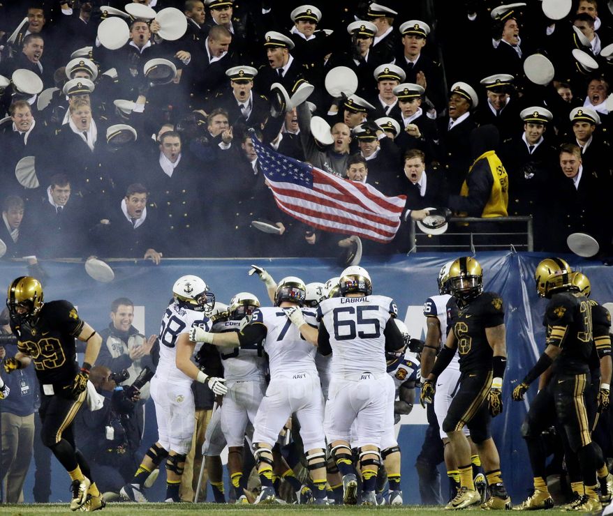 Navy players celebrate after a touchdown by quarterback Keenan Reynolds during the second half of an NCAA college football game against Army, Saturday, Dec. 8, 2012, in Philadelphia. Navy won 17-13. (AP Photo/Matt Slocum)