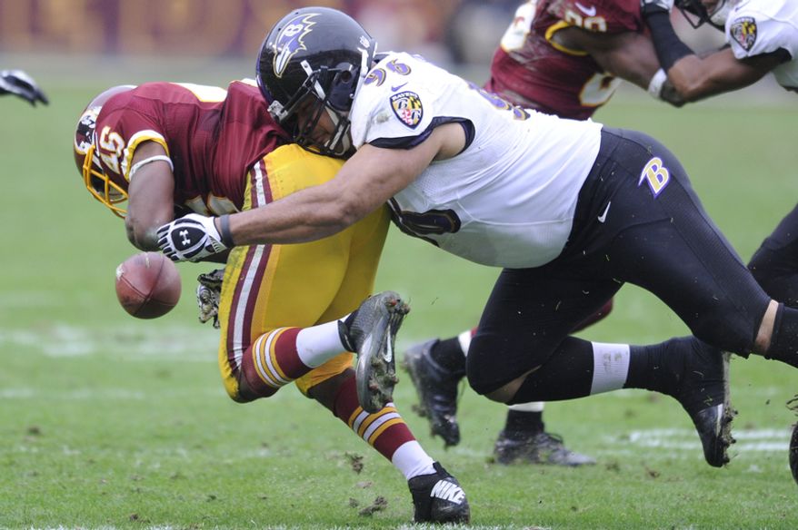 Baltimore Ravens nose tackle Ma'ake Kemoeatu (96) forces Washington Redskins running back Alfred Morris (46) to fumble in the second quarter at FedEx Field, Landover, Md., Dec. 9, 2012. (Preston Keres/Special to The Washington Times)
