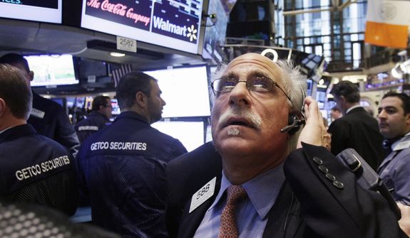 **FILE** Trader Peter Tuchman works on the floor of the New York Stock Exchange in New York on Dec. 6, 2012. (Associated Press)