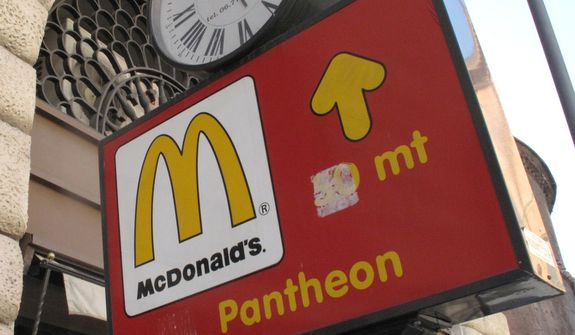 **FILE** A sign points to the McDonald's restaurant near the historic Pantheon in Rome on June 28, 2011. (Associated Press)