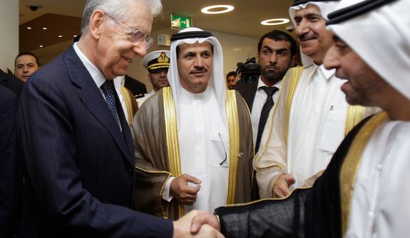 **FILE** Italian prime minister Mario Monti (left) shakes hands with a UAE official as he arrives Nov. 20, 2012, to the UAE-Italy Business Forum at the Dubai Chamber of Commerce & Industry in Dubai, United Arab Emirates, with Sultan bin Saeed al Mansoori, UAE minister of economy (second left). (Associated Press)