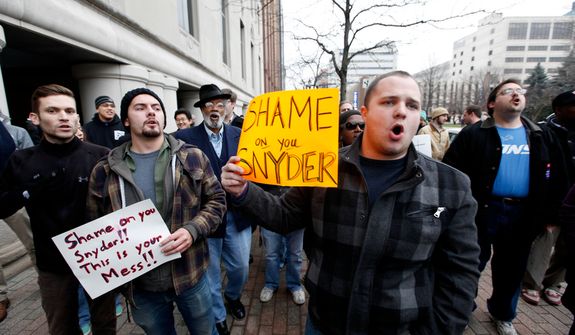 Demonstrators protest right-to-work legislation in the outside the George W. Romney State Office building, where Gov. Snyder's office is located, in Lansing, Mich., Friday, Dec. 7, 2012. Michigan could become the 24th state with a right-to-work law next week. Rules require a five-day wait before the House and Senate vote on each other's bills; lawmakers are scheduled to reconvene Tuesday and Gov. Snyder has pledged to sign the bills into law. (AP Photo/Paul Sancya)