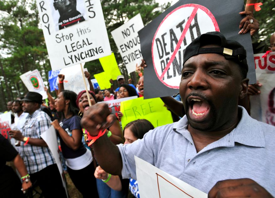 **FILE** Demonstrators chant slogans against the death penalty at a Sept. 21, 2011, rally in Jackson, Ga., for Georgia death row inmate Troy Davis, who was executed later that day for the 1991 murder of a police officer. (Associated Press)