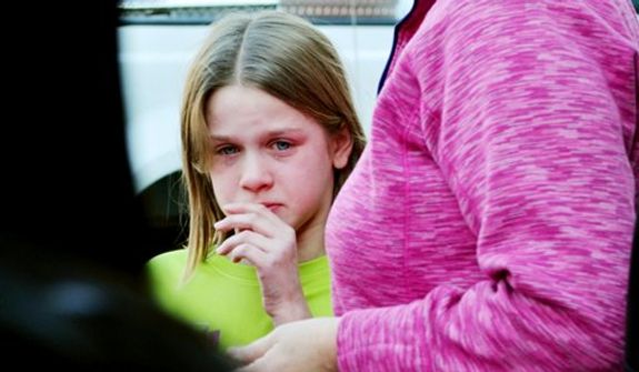 A young girl cires following a shooting at the Sandy Hook Elementary School in Newtown, Conn., about 60 miles (96 kilometers) northeast of New York City, Friday, Dec. 14, 2012. An official with knowledge of Friday's shooting said 27 people were dead, including 18 children. (AP Photo/The New Haven Register, Melanie Stengel)