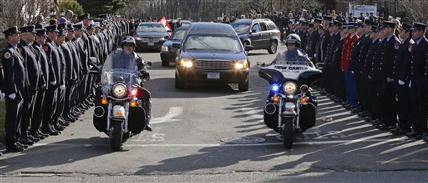 Firefighters stand as the procession heads to the cemetery outside the funeral for school shooting victim Daniel Gerard Barden at St. Rose of Lima Catholic Church in Newtown, Conn., Wednesday, Dec. 19, 2012. According to firefighters, Daniel wanted to be a firefighter when he grew up and they honored him at the service. Barden, 7, was killed when Adam Lanza walked into Sandy Hook Elementary School in Newtown, Conn., Dec. 14, and opened fire, killing 26 people, including 20 children, before killing himself. (AP Photo/Charles Krupa)