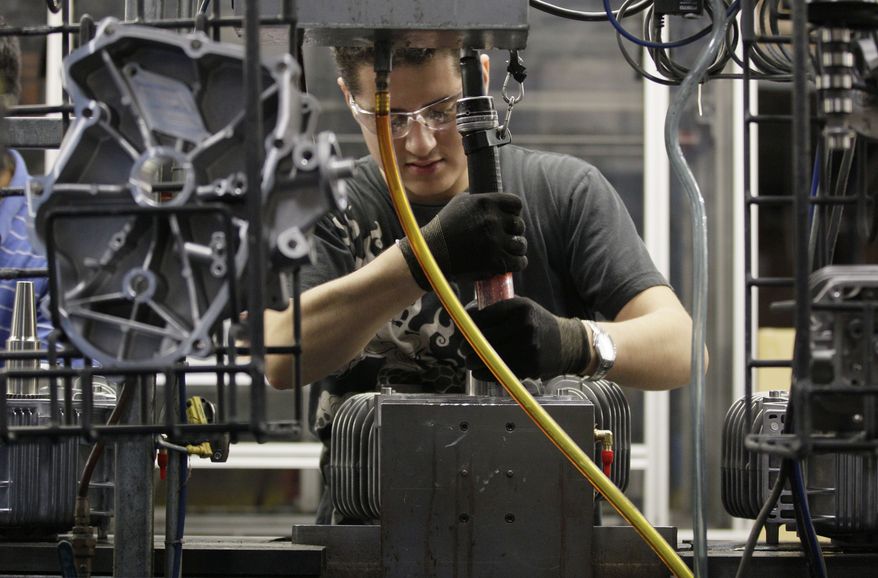 Jesus Serna works on the assembly line at Generac Power Systems Inc., one of the largest makers of residential generators in the United States, in Whitewater, Wis., on Friday, Nov. 16, 2012. (AP Photo/Nam Y. Huh)
