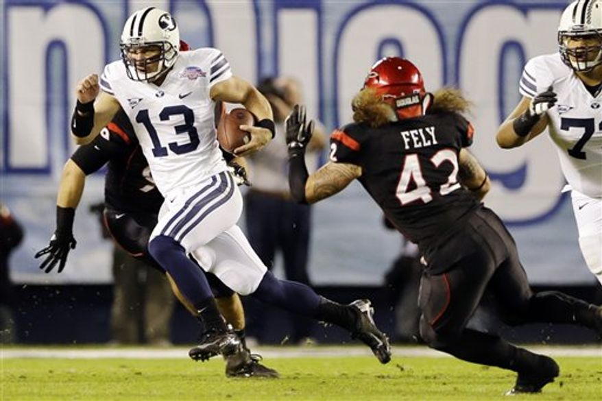 BYU quarterback Riley Nelson scrambles for a 13-yard gain and a first down against San Diego State during the first half of the Poinsettia Bowl college football game, Thursday, Dec. 20, 2012, in San Diego. (AP Photo/Lenny Ignelzi)