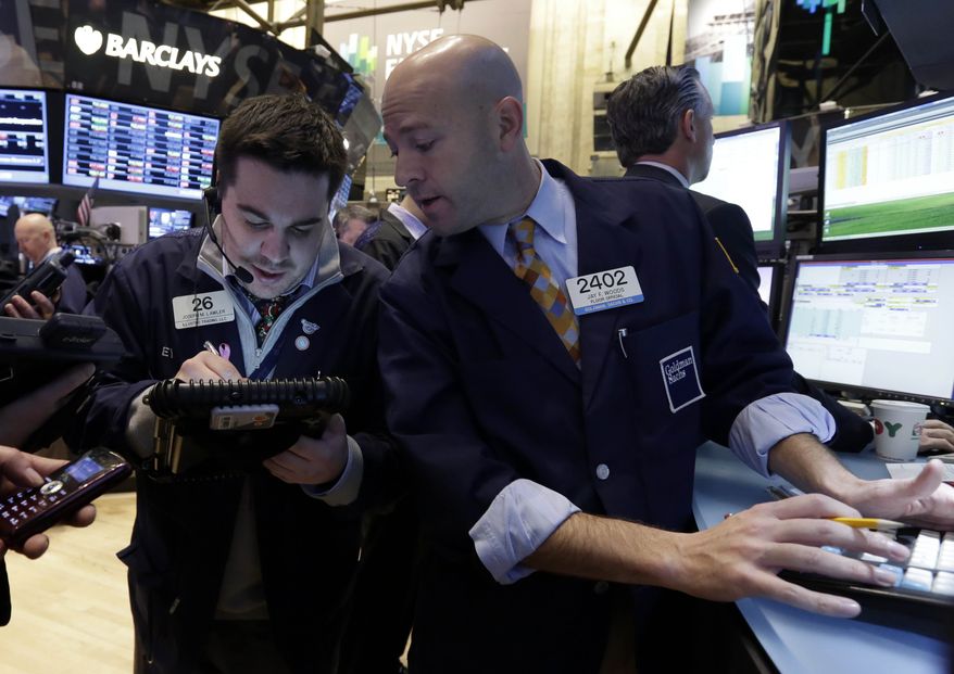 Trader Joseph Lawler, left, and specialist Jay Woods work on the floor of the New York Stock Exchange Friday, Dec. 21, 2012. Stocks opened sharply lower Friday on Wall Street after House Republicans called off a vote on tax rates and left federal budget talks in disarray 10 days before sweeping tax increases and government spending cuts take effect. (AP Photo/Richard Drew)