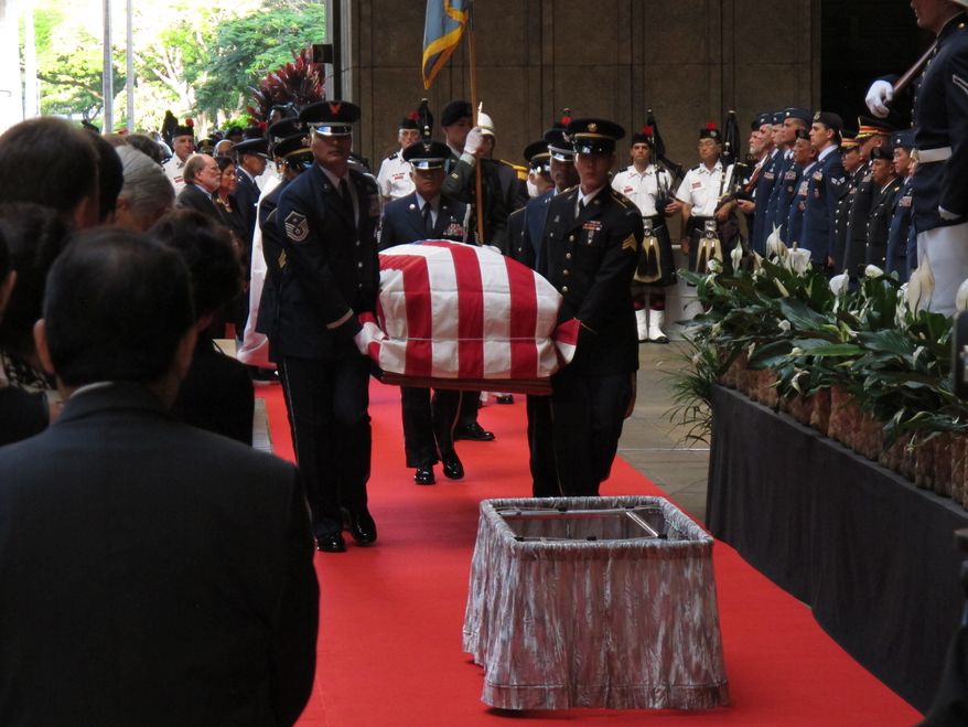 Pallbearers carry the casket of U.S. Sen. Daniel K. Inouye into the courtyard of the Hawaii Capitol during a visitation ceremony in Honolulu on Saturday, Dec. 22, 2012. (AP Photo/Oskar Garcia)