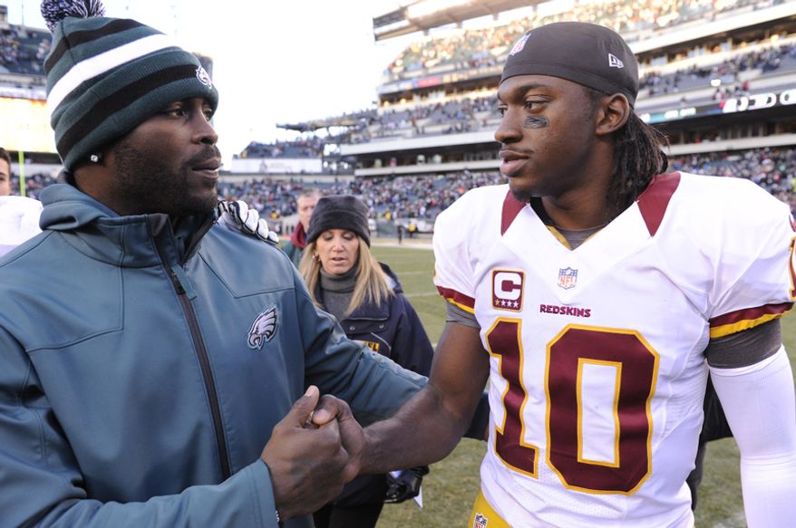 Philadelphia Eagles quarterback Michael Vick (L) talks with Washington Redskins quarterback Robert Griffin III (10) after the game at Lincoln Financial Field, Philadelphia, Pa., Dec. 23, 2012. (Preston Keres/Special to The Washington Times)