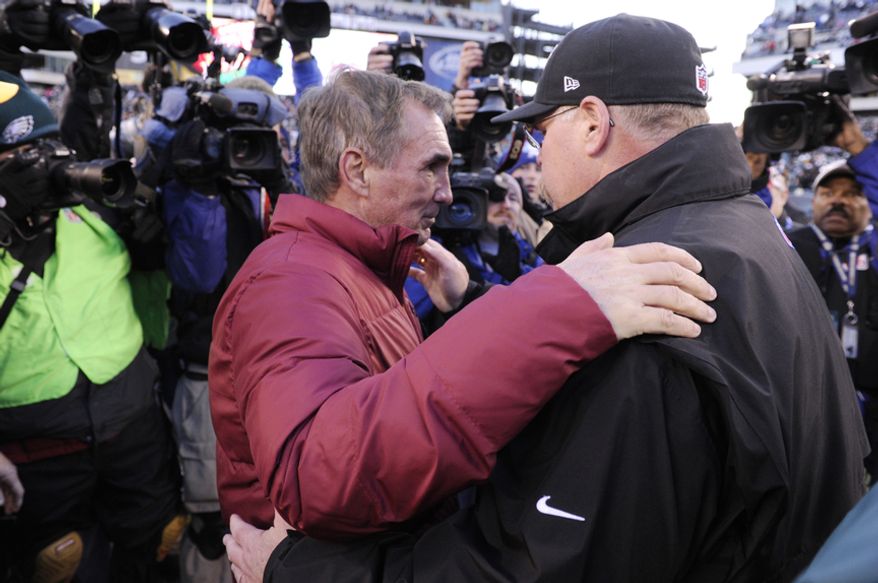 Washington Redskins head coach Mike Shanahan (L) greets Philadelphia Eagles head coach Andy Reid at midfield after a 27-20 Redskins victory at Lincoln Financial Field, Philadelphia, Pa., Dec. 23, 2012. (Preston Keres/Special to The Washington Times)