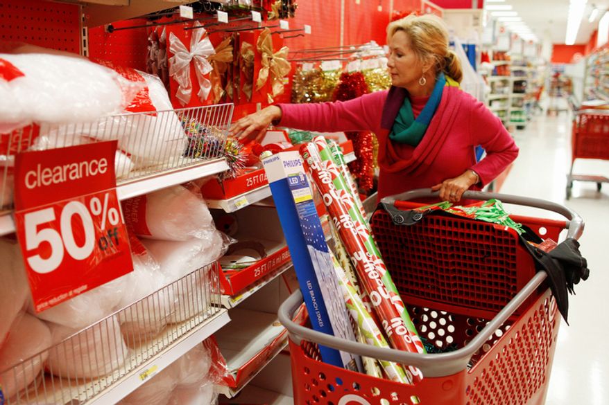 ** FILE ** Holly Bryan stocks up on Christmas wrapping paper and other holiday items while shopping for day after Christmas deals at a Target store in Chattanooga, Tenn., Wednesday, Dec. 26, 2012. (AP Photo/Chattanooga Times Free Press, Dan Henry)