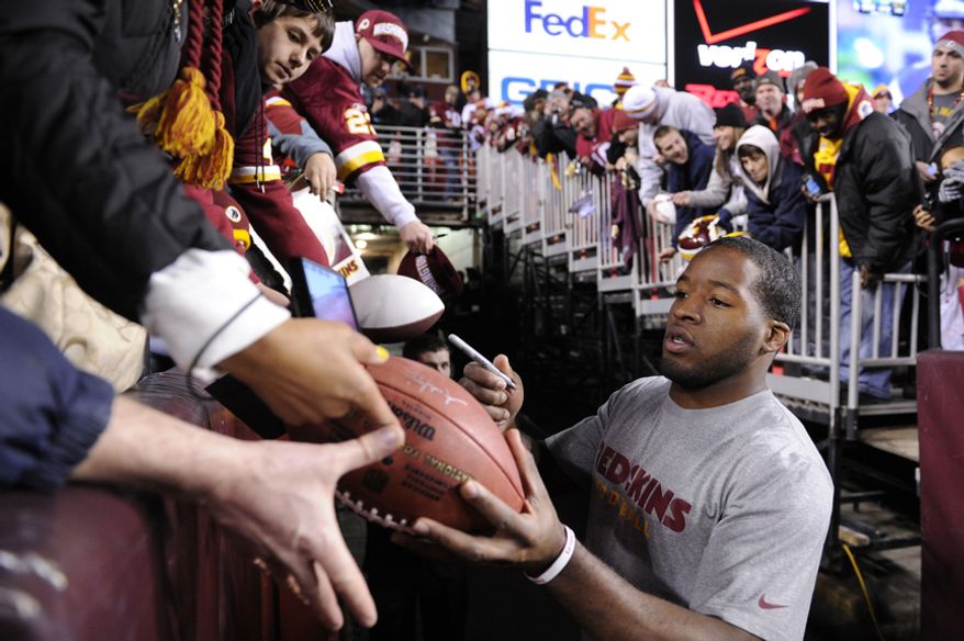 Washington Redskins running back Alfred Morris signs autographs for the fans before the game versus the Dallas Cowboys at FedEx Field, Landover, Md., Dec. 30, 2012. (Preston Keres/Special to The Washington Times)