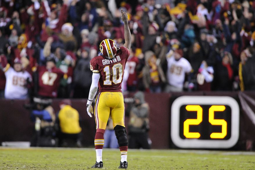 Washington Redskins quarterback Robert Griffin III (10) celebrates running back Alfred Morris' 32-yard touchdown run in the fourth quarter at FedEx Field, Landover, Md., Dec. 30, 2012. (Preston Keres/Special to The Washington Times)