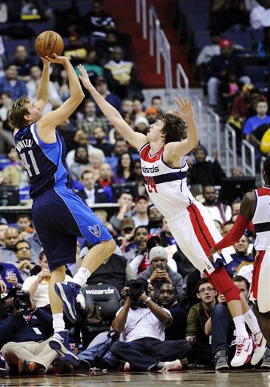 Dallas Mavericks forward Dirk Nowitzki (41) shoots against Washington Wizards forward Jan Vesely (24) during the second half of an NBA game, Tuesday, Jan. 1, 2013, in Washington. Dallas won 103-94. (AP Photo/Nick Wass)