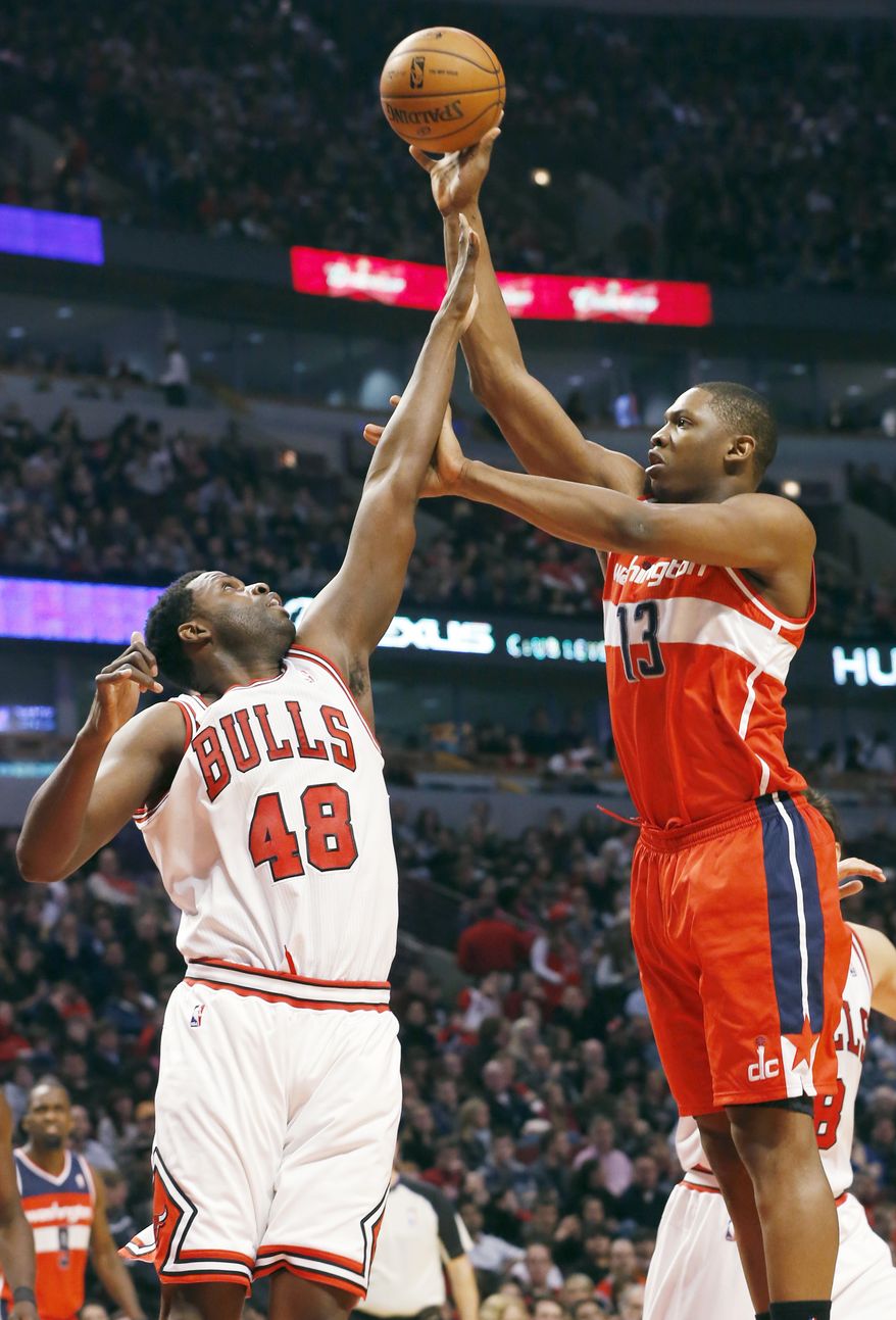 Washington Wizards center Kevin Seraphin, of France, right, shoots over Chicago Bulls center Nazr Mohammed during the first half of an NBA basketball game in Chicago on Saturday, Dec. 29, 2012. (AP Photo/Nam Y. Huh)