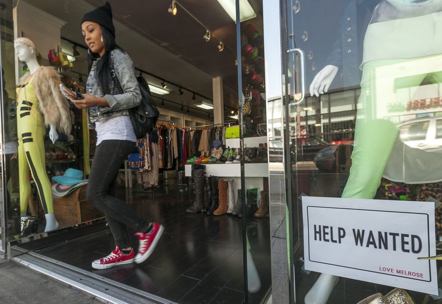 **FILE** A "help wanted" sign is posted on the front window of a clothing boutique in Los Angeles on Dec. 7, 2012. (Associated Press)