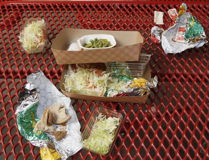 ** FILE ** This Jan. 17, 2012, file photo shows vegetables left over by students on their cafeteria trays at the Roosevelt High School in Los Angeles. (AP Photo/Damian Dovarganes, File)