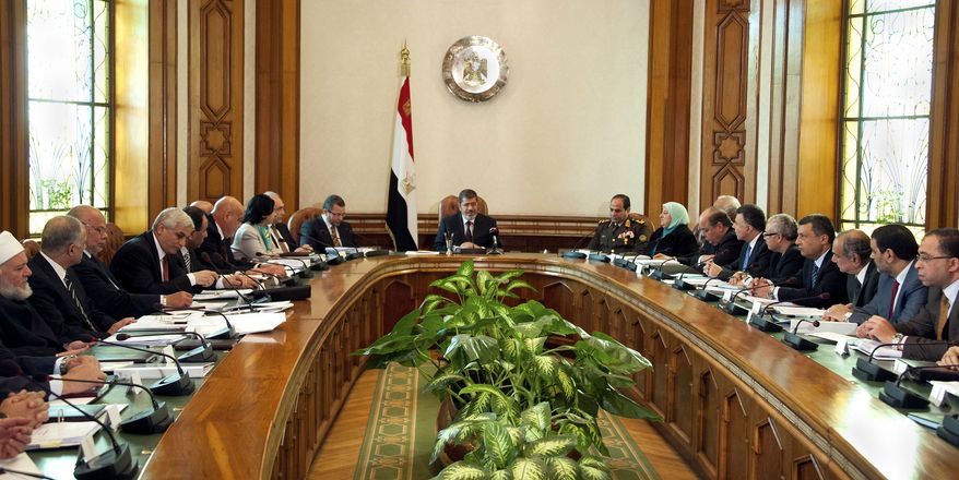 President Mohammed Morsi (center) meets with his Cabinet, including 10 new ministers after their swearing in, at the presidential palace in Cairo on Sunday, Jan. 6, 2013. (AP Photo/Egyptian Presidency)