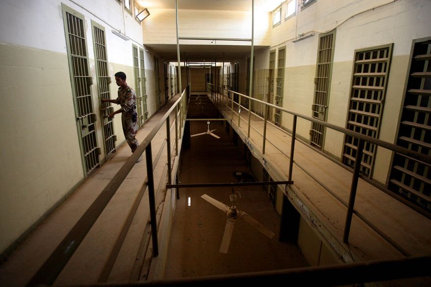 **FILE** An Iraqi army soldier closes the door of a cell in Abu Ghraib prison on the outskirts of Baghdad on Sept. 2, 2006, after the Iraqi government took over control from U.S. forces. (Associated Press)
