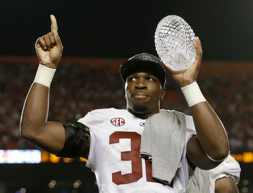 Alabama's C.J. Mosley holds up The Coaches' Trophy after the BCS National Championship college football game against Notre Dame Monday, Jan. 7, 2013, in Miami. Alabama won 42-14. (AP Photo/David J. Phillip)