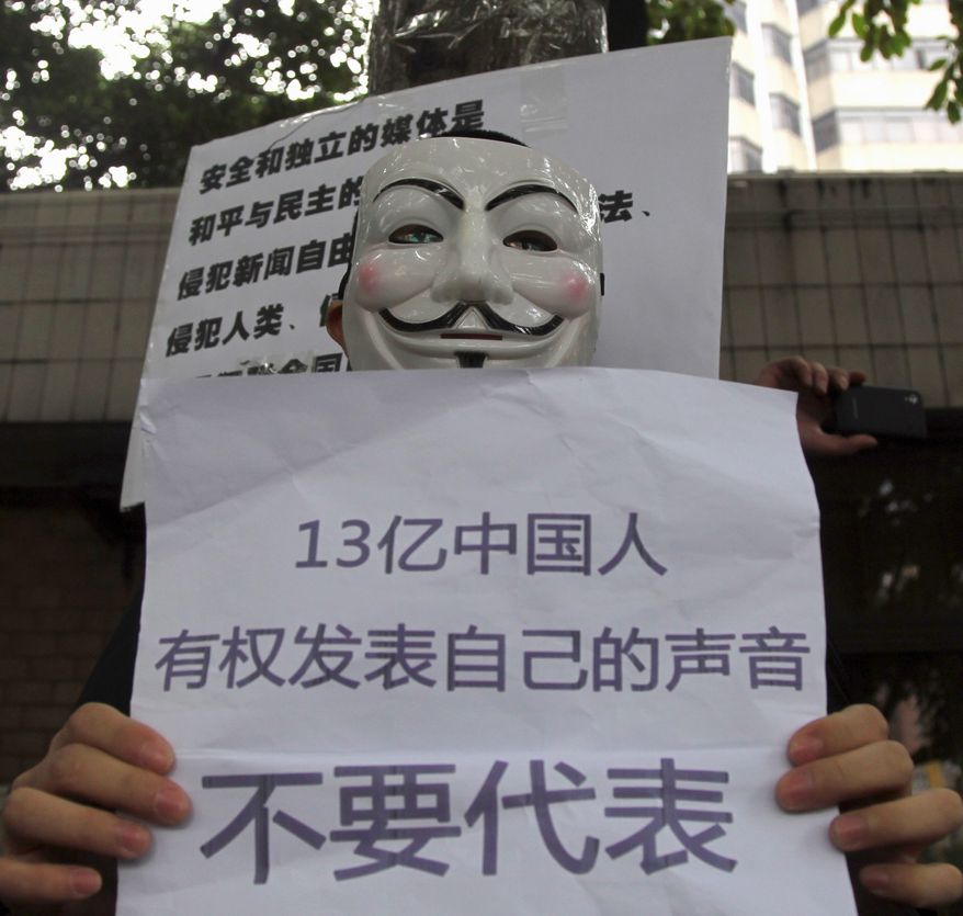 A supporter of the Southern Weekly protests in Guangzhou with a banner that translates as "1.3 billion Chinese have rights to their own voice and do not want to be represented." (Associated Press)
