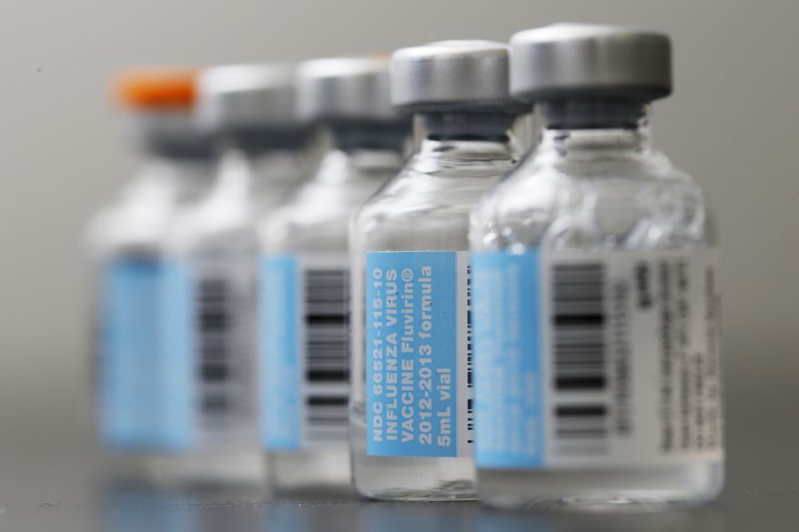 ** FILE ** Vials of flu vaccine are displayed on Jan. 10, 2013, at Philly Flu Shots in Philadelphia. (Associated Press)