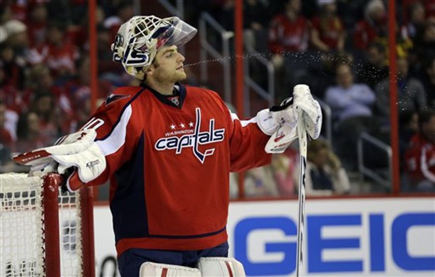 Washington Capitals goalie Braden Holtby (70) spits water during a timeout in the third period of an NHL hockey game against the Winnipeg Jets Tuesday, Jan. 22, 2013 in Washington. The Jets won 4-2. (AP Photo/Alex Brandon)