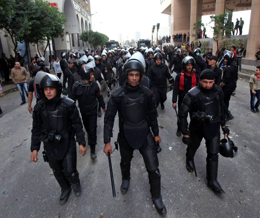 associated press
Egyptian riot police gird for clashes with protesters in Cairo on Wednesday. Political violence has left more than 60 dead in the past week, and the head of the armed forces warned of the potential for political chaos.
