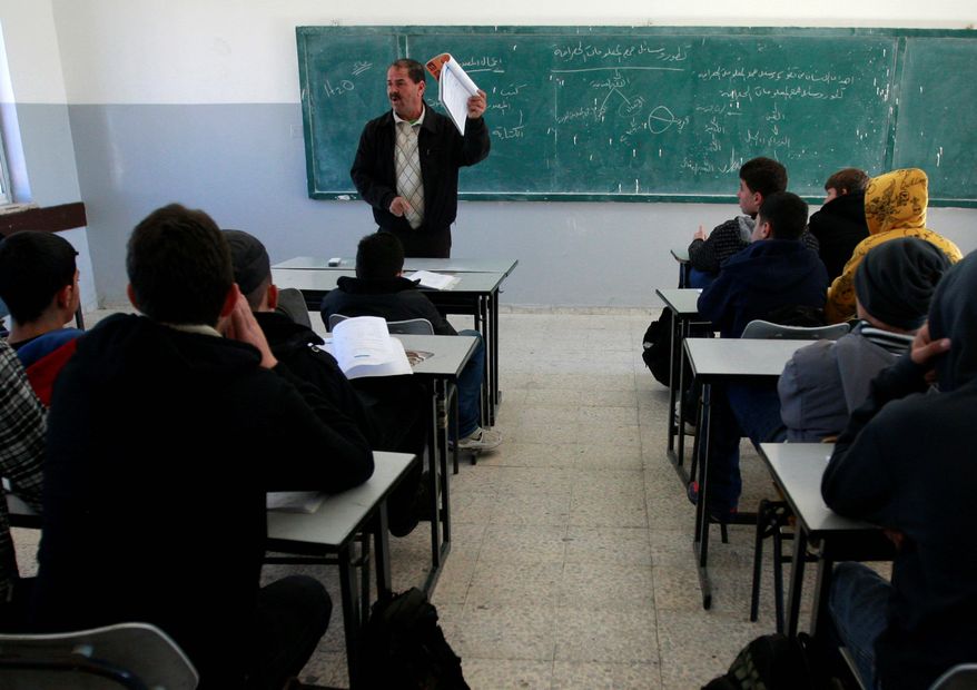 Palestinian students attend class in a Ramallah, West Bank, school Sunday. A U.S.-funded study released Monday said both Israeli and Palestinian schoolbooks largely present one-sided narratives of the two sides' conflict. (Associated Press)