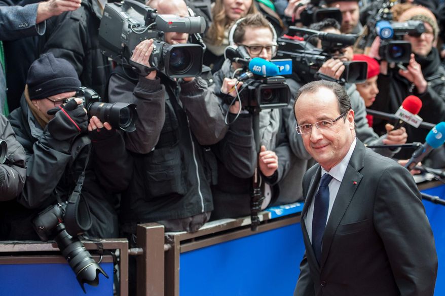 ** FILE ** French President Francois Hollande arrives during an EU Budget summit at the European Council building in Brussels, Thursday, Feb. 7, 2013. (AP Photo/Geert Vanden Wijngaert)