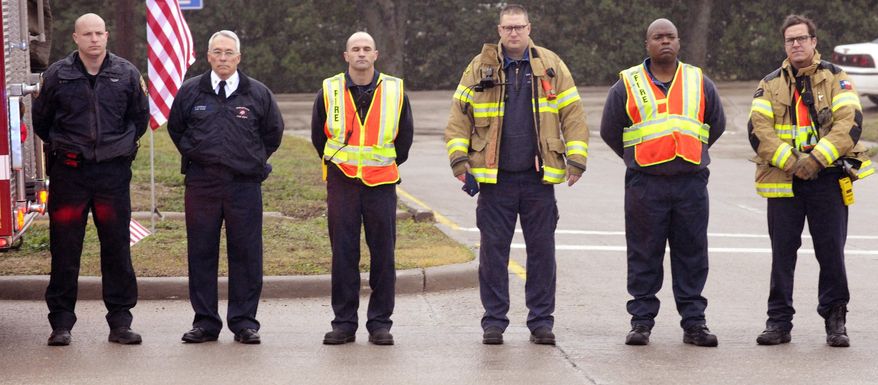 Members of Midlothian Fire Department pay their respects during a procession for Chris Kyle in Midlothian, Texas, Tuesday, Feb. 12, 2013, for the 200-mile journey to Austin, where Kyle will be buried at the Texas State Cemetery. Some 7,000 people attended a two-hour memorial service for Kyle at Cowboys Stadium in Arlington on Monday. Kyle and his friend Chad Littlefield were shot and killed Feb 2. at a North Texas gun range. (AP Photo/Star-Telegram, Max Faulkner)