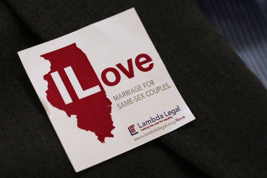 **FILE** A supporter of same sex-marriage wears a sticker on her jacket before attending a state Senate Executive Committee hearing on the topic at the Illinois Capitol in Springfield, Ill., on Jan. 3, 2013. (AP Photo/Seth Perlman)